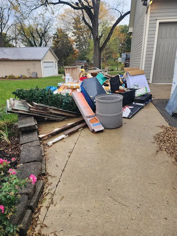 Dumpster being loaded with debris for 12 Yard Dumpster Rental in Suitland